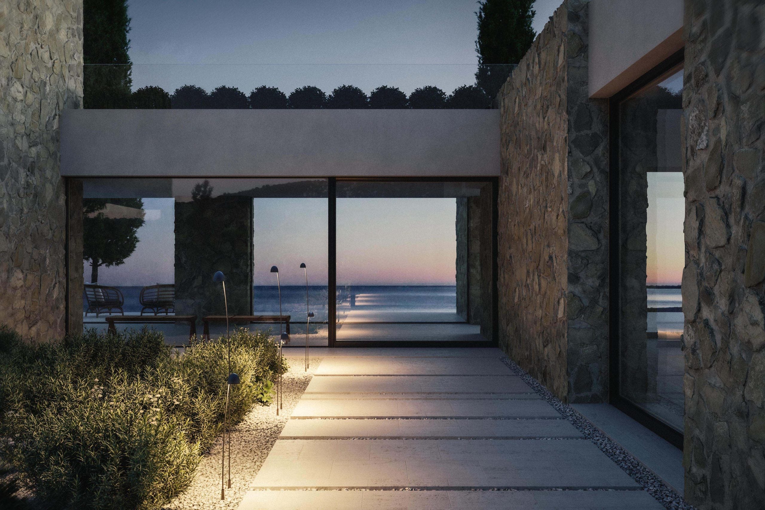 Cioèt bollard lights beside a landscaped entrance at dusk