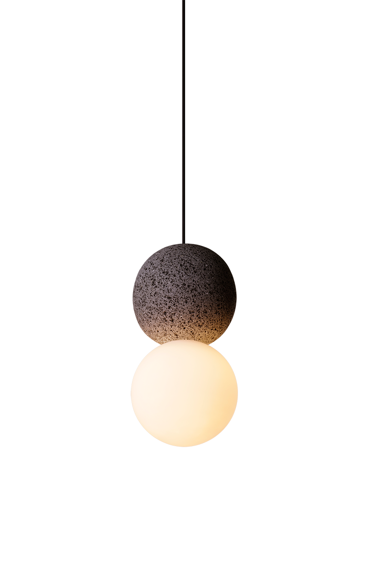 Product shot of the Origo pendant lamp with volcanic stone and glass globe.