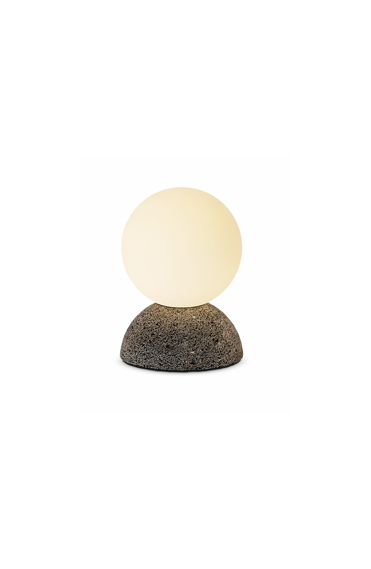 Studio shot of a stone-base globe lamp against a neutral background.