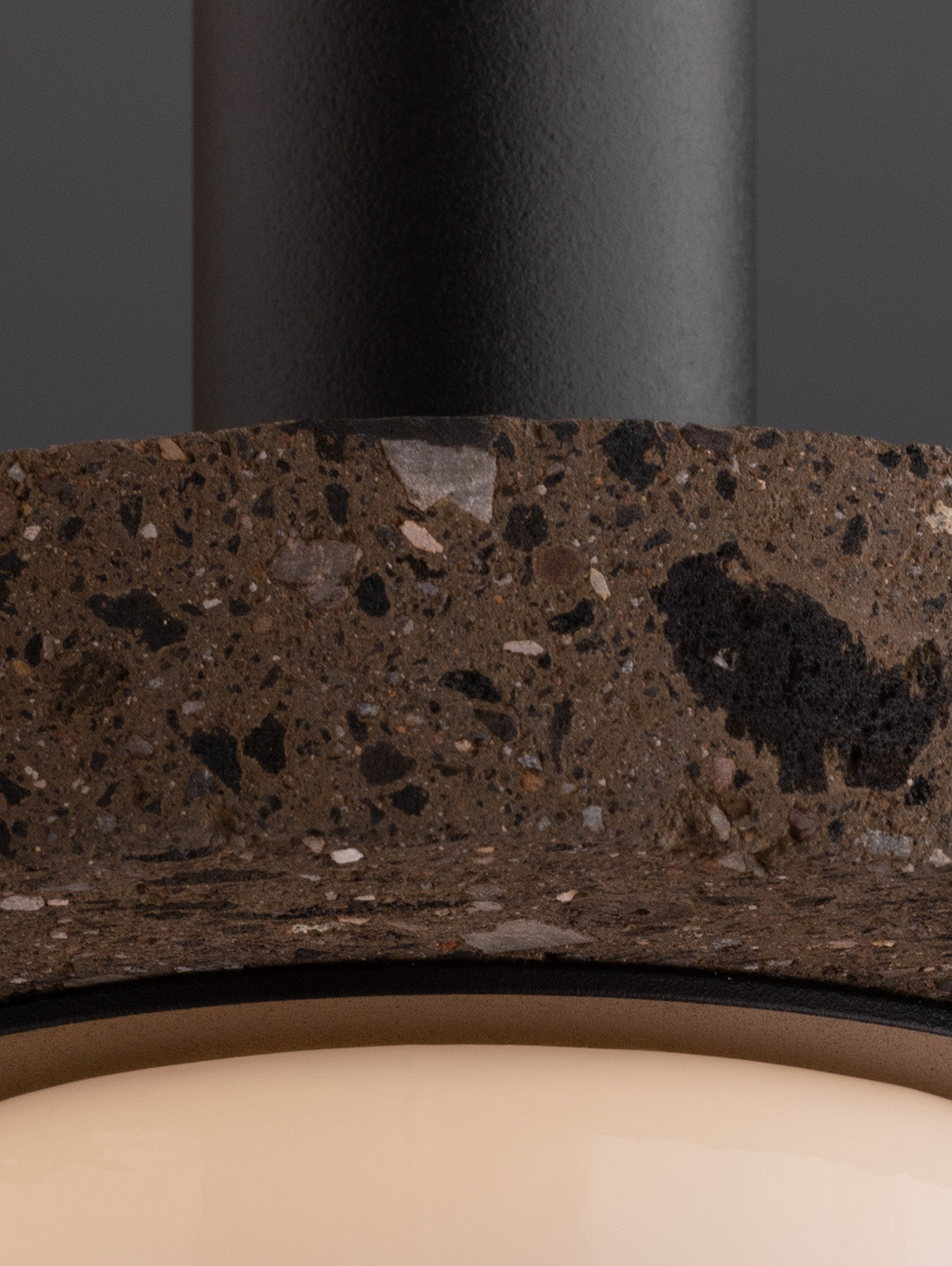 Close-up of a textured material with a dark gray color on a black background