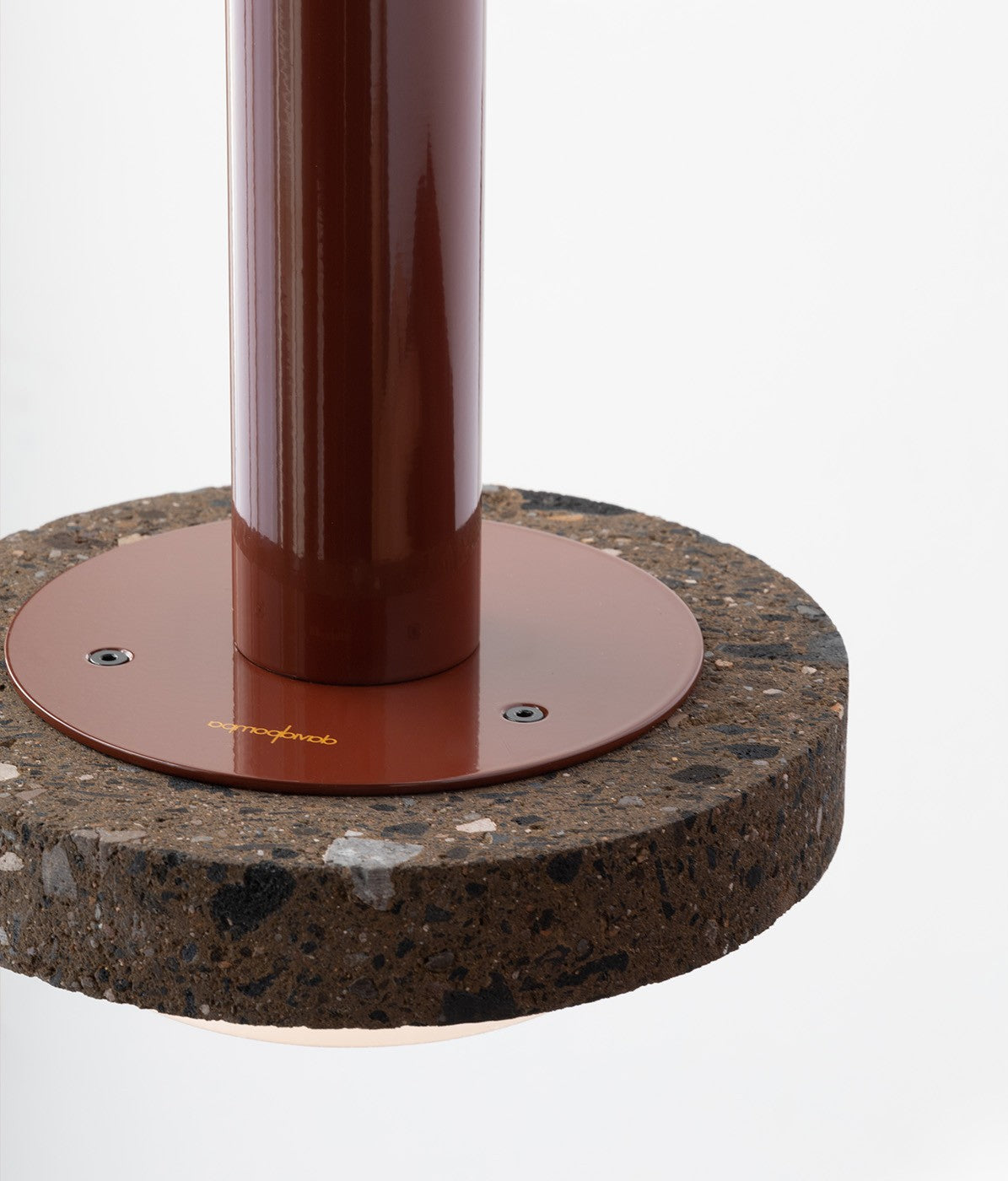 Round stone base with a metallic column on a white background