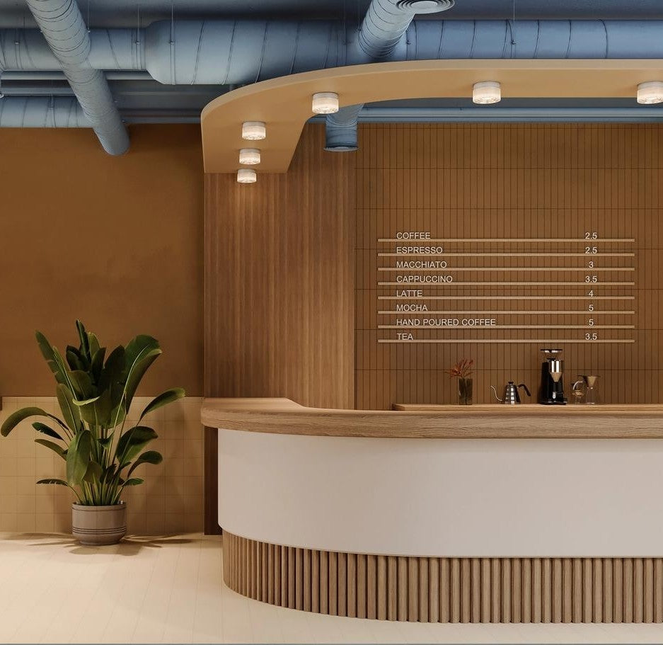 Modern coffee shop interior with a counter and menu board.