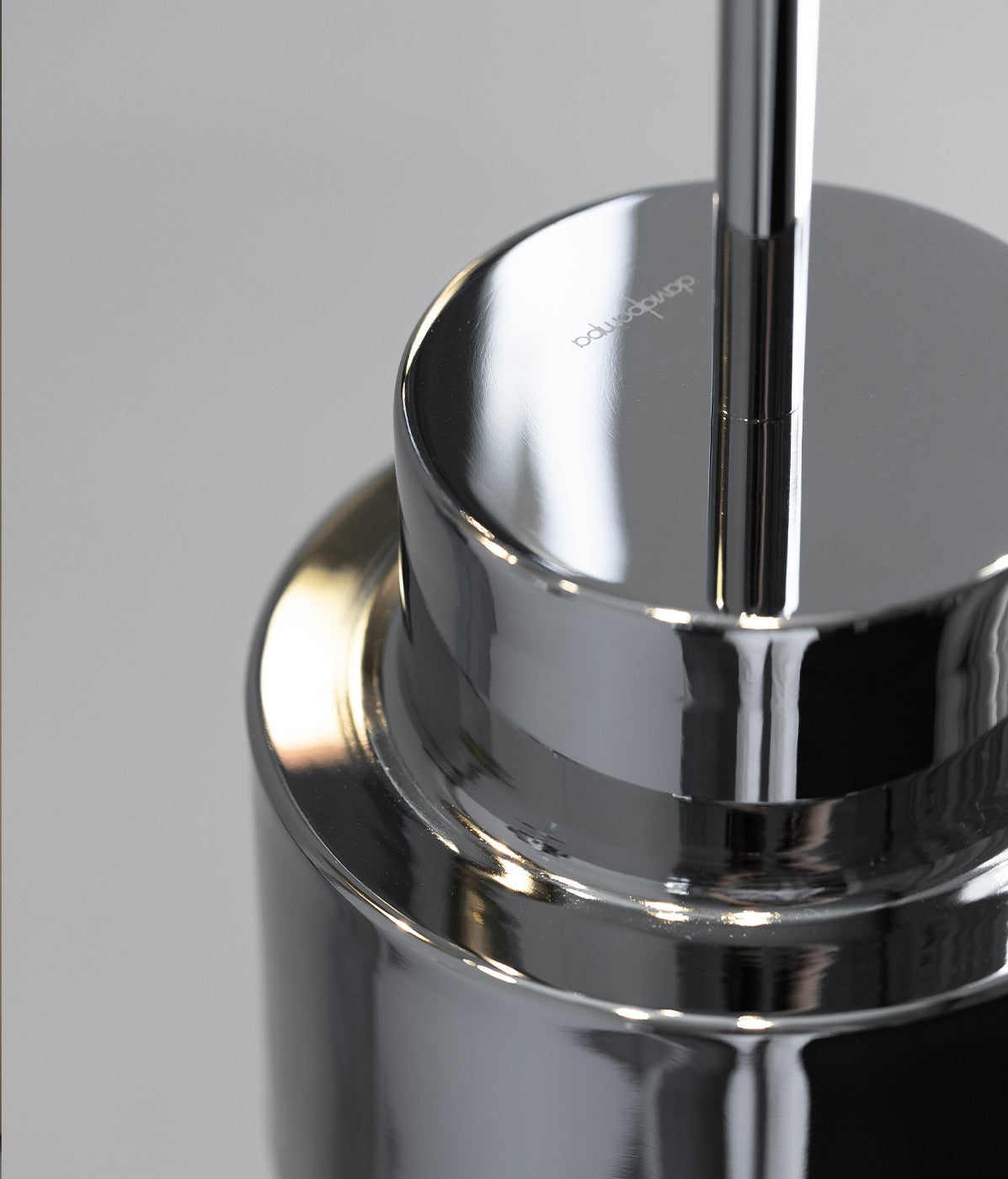 Sleek chrome pendant light with a reflective surface, adding shine to the modern space.
